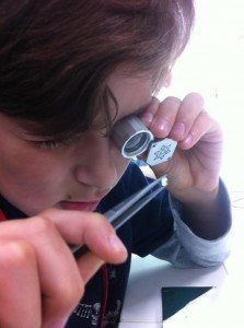 young boy inspecting jewellery