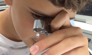 Young Boy Inspecting Diamond