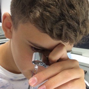 Young Boy Inspecting Diamond