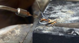 Jeweller moulding ring in workshop