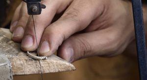 Jeweller working on ring in workshop