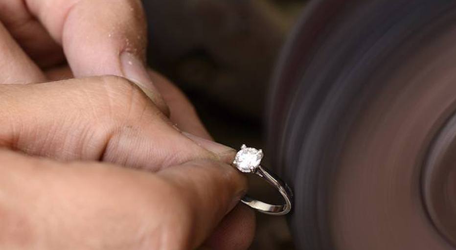 Diamond Ring Being Polished by Jeweller in Workshop