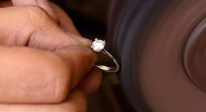 Jeweller polishing diamond ring