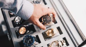 Man selecting watch from collection box